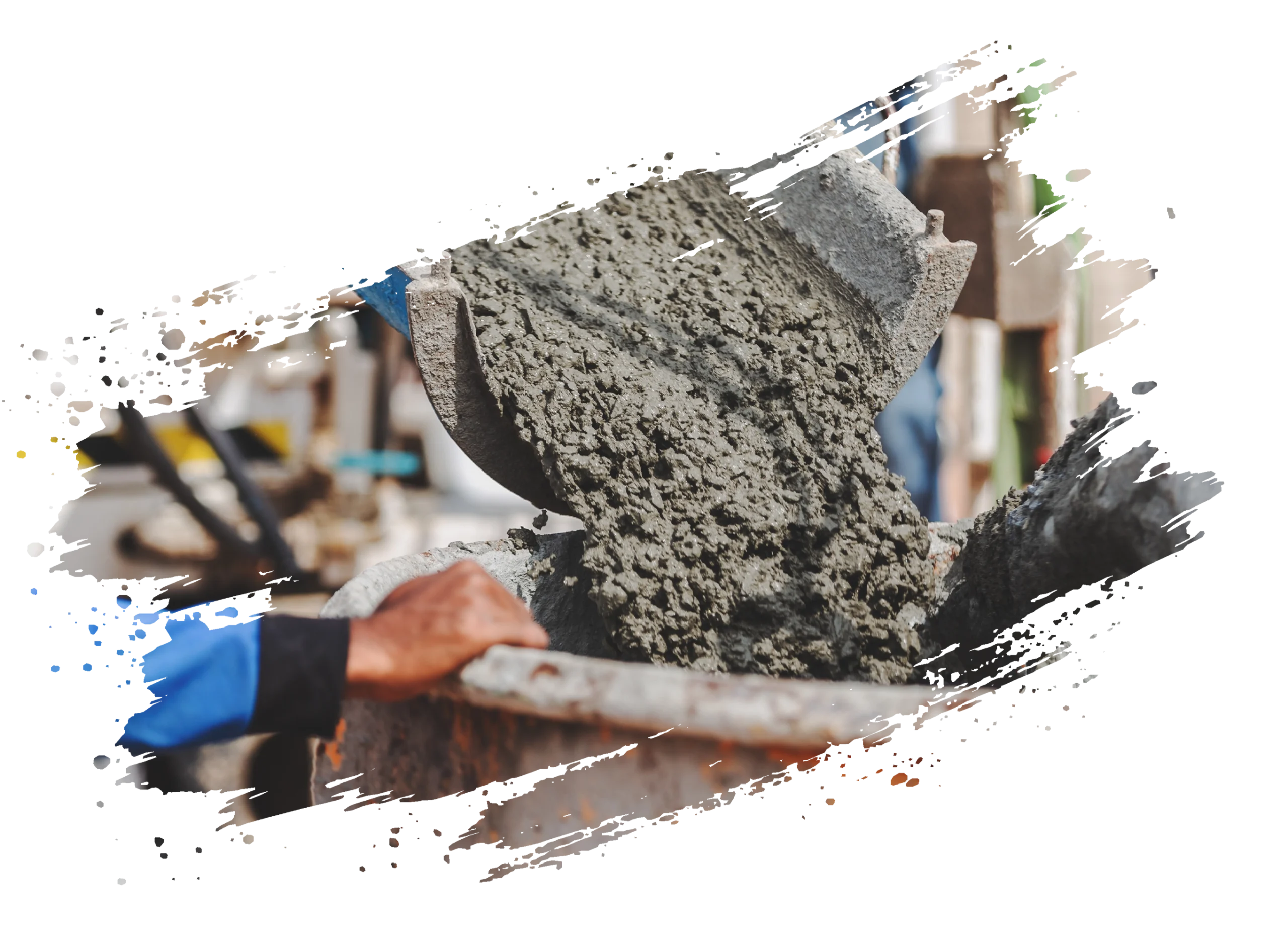 Ein Arbeiter gießt zähflüssigen Beton aus einem rostigen Behälter in eine Schubkarre auf einer Baustelle.